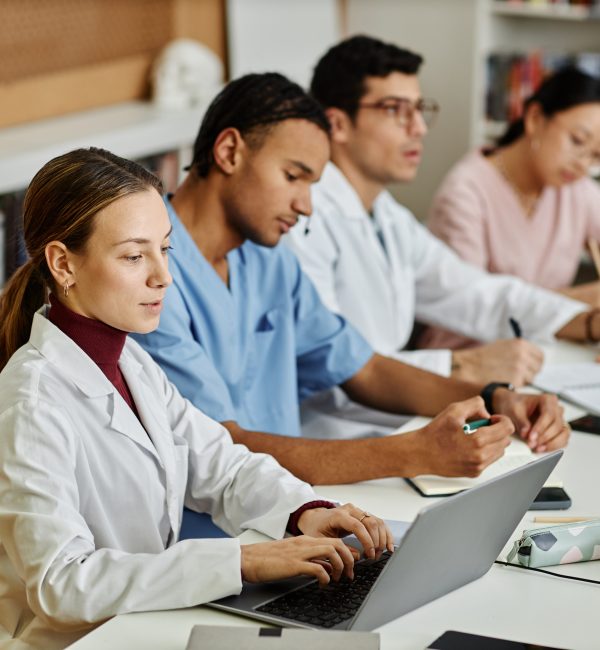 group of young med students sitting in row during lecture or seminar